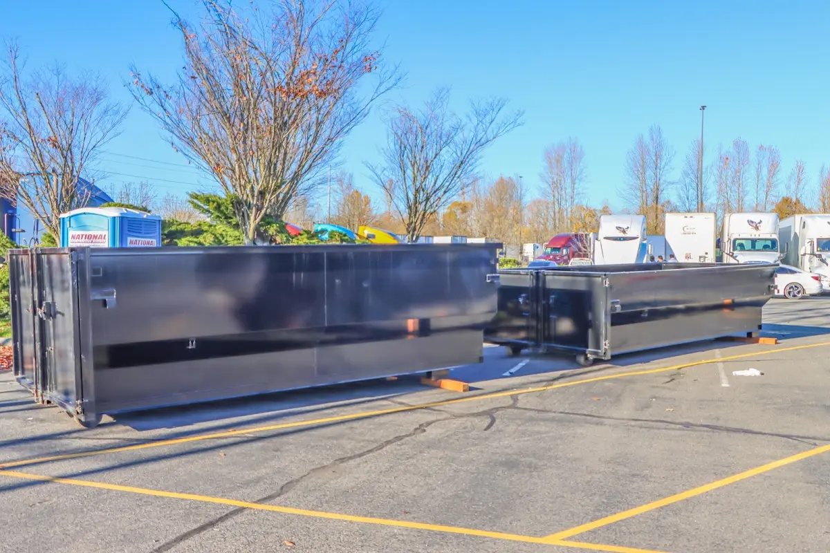 Professional dumpster rental service with roll-off container on residential driveway in Tonganoxie